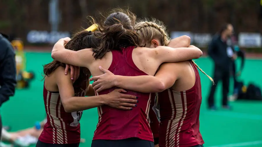 athletes in huddle